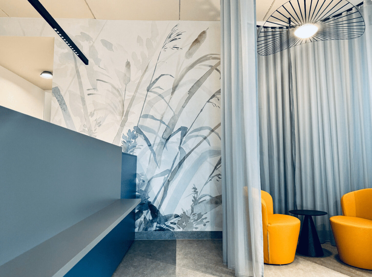 Ausstattung einer gynäkologischen Wahlarztpraxis. Ordination mit safran und blauen Tönen.